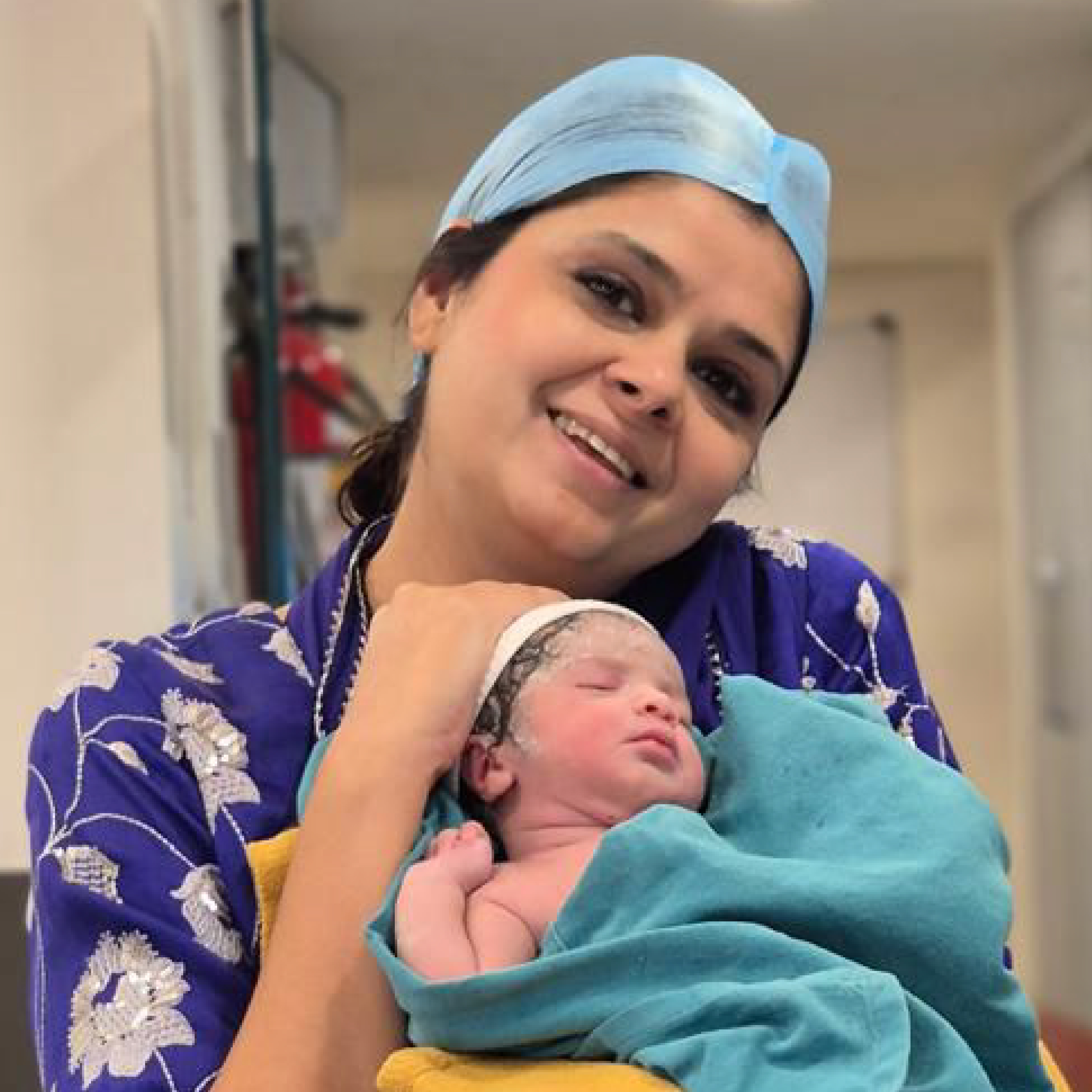 HomeIVF doctors and nurses celebrating a newborn baby right after delivery